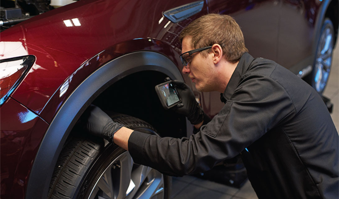 man inspecting tire
